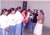 women passing out hats to trainees