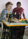 Demonstrating sewing machine use at school opening