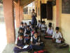 Mhaskal school children reading with monitor