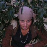 woman carrying load of leaves