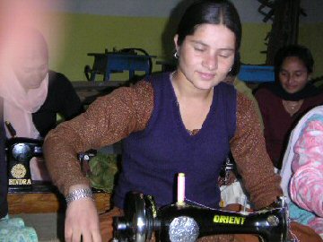 woman using sewing machine