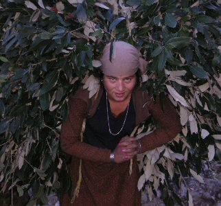 Girl carrying load of leaves on back