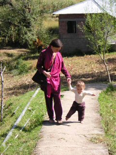 Isabelle in a village with her baby.